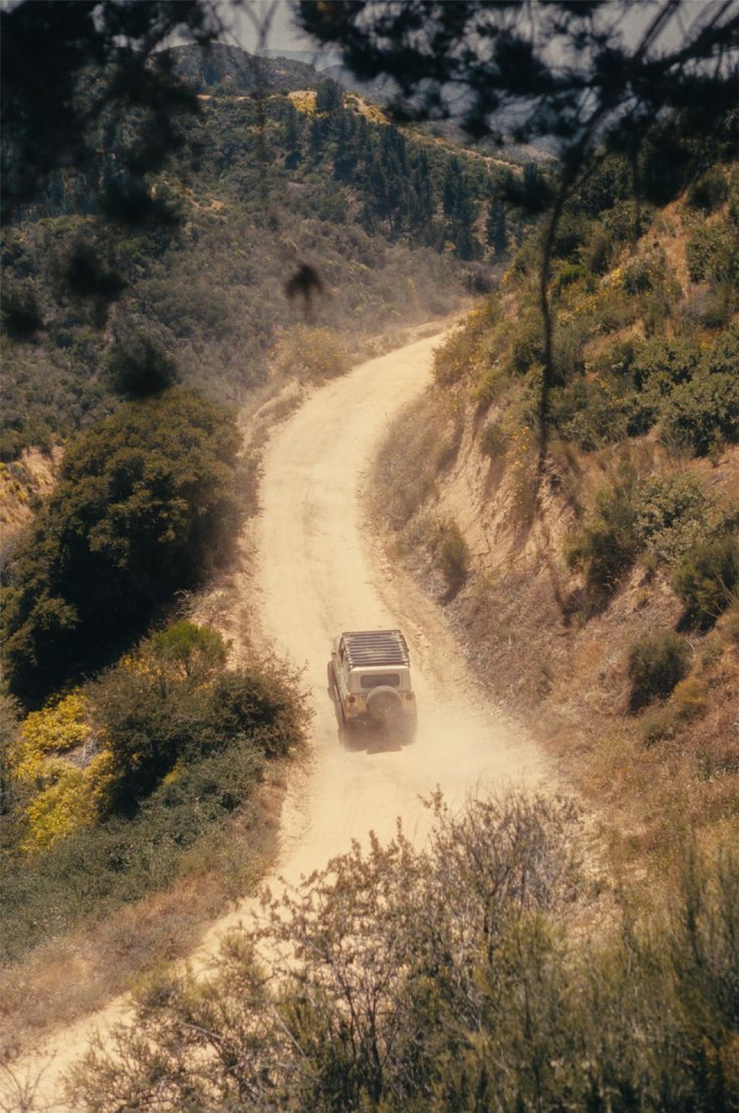 A four-wheel drive on a dusty back-country road
